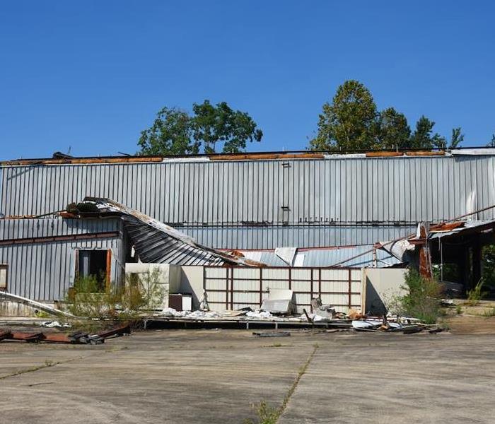 Storm damage collapses a roof of a warehouse in rural Louisiana.