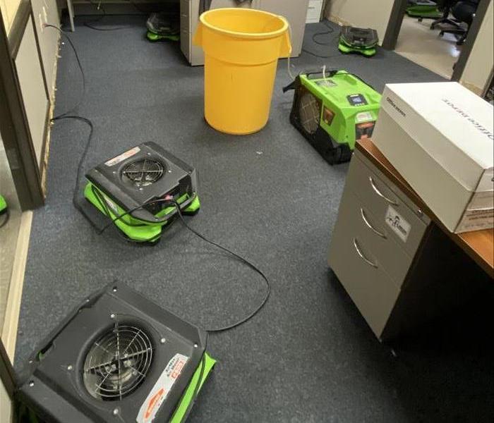 SERVPRO drying equipment being used in a commercial office setting to treat water damage.